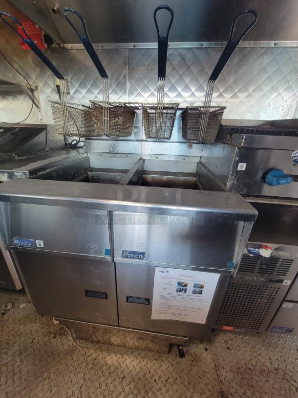 2020 16' Quality food trailer interior with Pitco gas fryer, econo-air hood, stainless steel walls, and diamond-plate flooring.