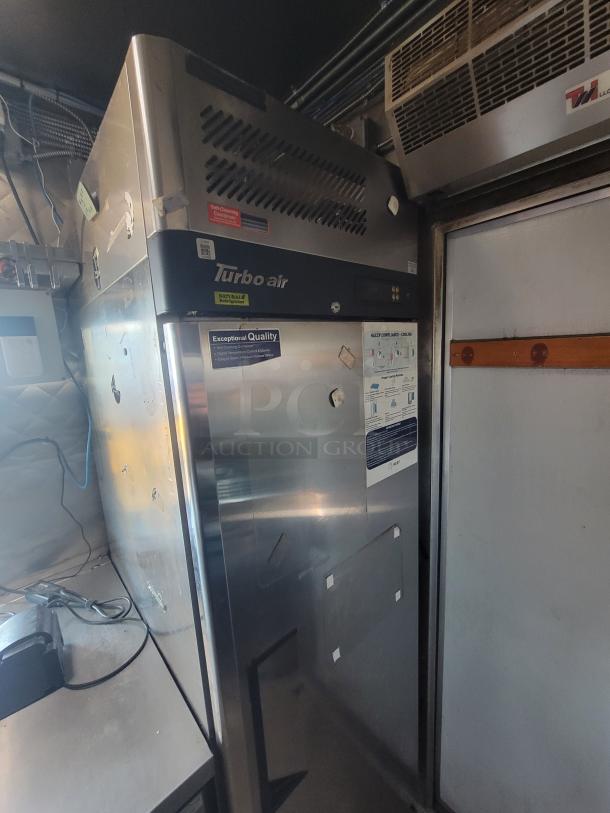 Turbo air refrigeration unit inside a 2020 Quality 16' food trailer. Stainless steel, stickers indicate quality and features.