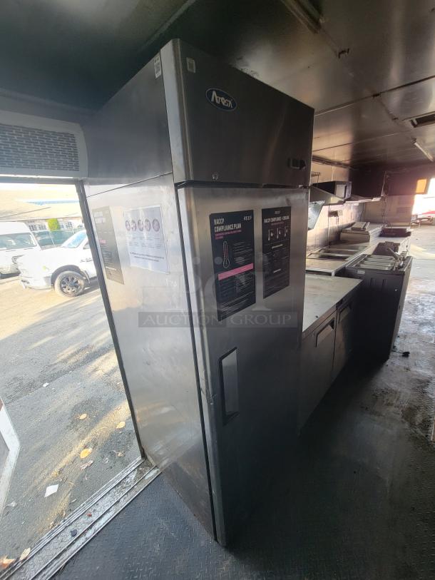 2019 Quality 24' food trailer interior, featuring Atosa refrigerator, prep area, and kitchen equipment. Good condition, VIN: 50ZZ1E424KN012861.