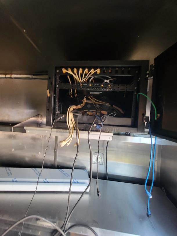 Interior view of a 2019 Quality 24' food trailer wiring setup. Visible cables and electrical panel for kitchen equipment.