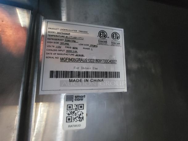 Label on the under-counter freezer MGF8406GR, showing specs: temperature range, refrigerant type R290, and made in China.