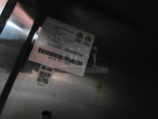 Close-up of a label inside the 2019 Quality 24' food trailer showing manufacturing details and a QR code.