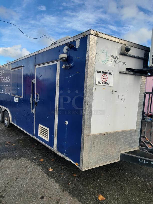 2019 Quality 24' commercial food trailer, blue exterior with visible "REEF KITCHENS" branding, and "NO SMOKING" sign.