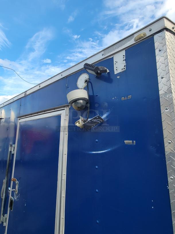 Blue 2019 24' Quality commercial food trailer exterior, featuring a security camera and metal finish details.