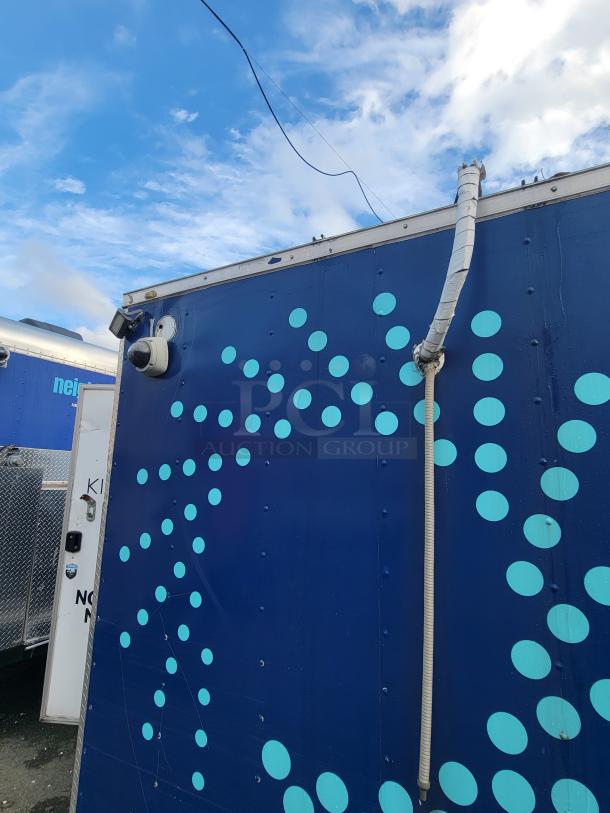 2019 24' Quality Commercial Food Trailer, blue with polka dots, exterior view showcasing security camera and vent.