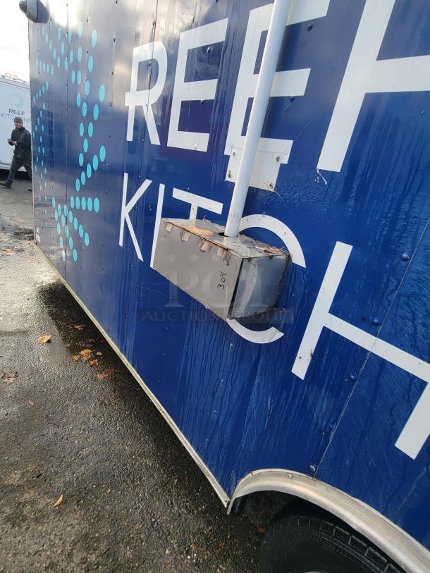 2019 Quality 24' food trailer, blue with "REEF Kitchens," electrical conduit visible. Ideal for commercial kitchen use.