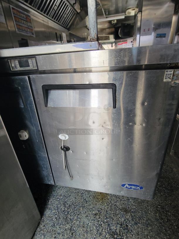 2019 24' Quality food trailer interior with stainless steel Arctica fridge, griddle, fryer, and exhaust hood.