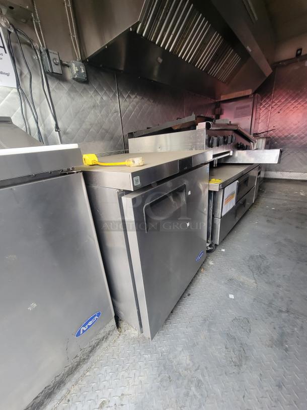 2018 Quality 16' NBRHD Kitchens food trailer interior with professional-grade kitchen equipment and stainless steel surfaces.