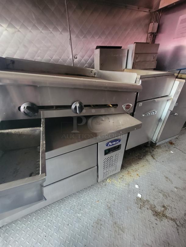 2018 16' NBRHD Kitchens food trailer interior with commercial kitchen equipment, stainless steel surfaces, and diamond plate flooring.
