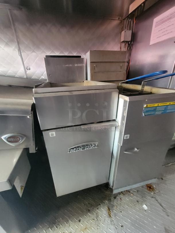 2018 16' NBRHD Kitchens food trailer interior featuring Imperial fryer and Wells appliance, stainless steel finish, excellent condition.