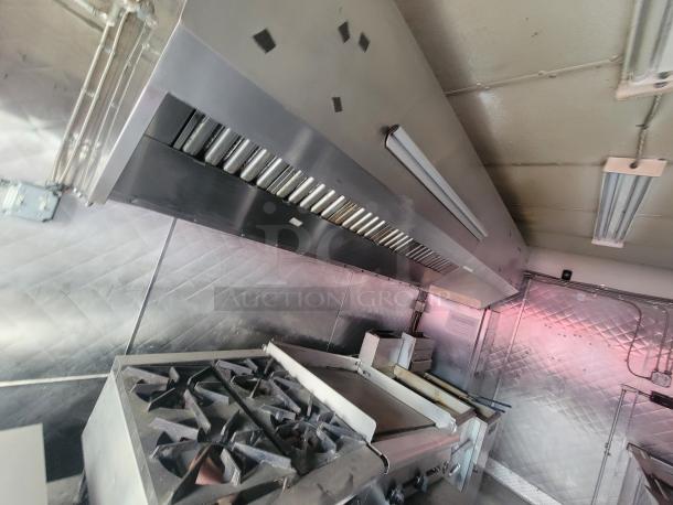 2018 16' NBRHD Kitchens food trailer interior with commercial-grade appliances, stainless steel finish, and ventilation system.