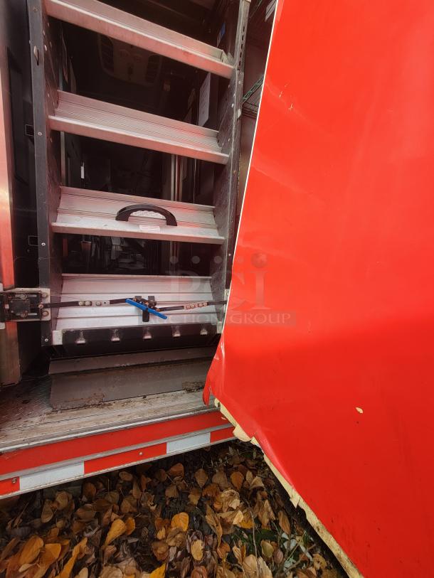 2021 Wendy's Mobile Ghost Kitchen trailer entrance showing interior steps and red door with minor wear.