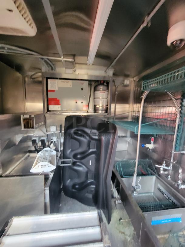 Interior of 2021 Wendy's Mobile Ghost Kitchen in a 28' Quality Trailer, featuring stainless steel counters and commercial appliances.