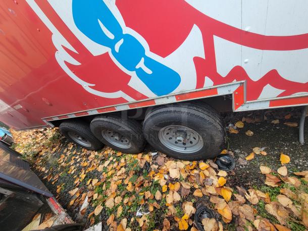 2021 Wendy's Mobile Ghost Kitchen trailer, 28' Titanium Cargo, triple axle, red branding, in good condition with fall leaves.
