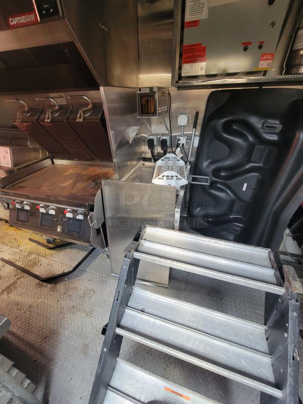2021 Wendy's Ghost Kitchen trailer interior; features commercial grill, stainless steel finish, and electrical setup.