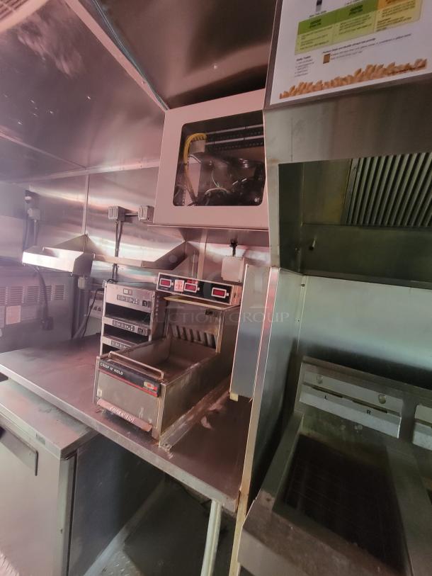 2021 Wendy's mobile ghost kitchen trailer interior with commercial appliances, stainless steel surfaces, and ventilation system.