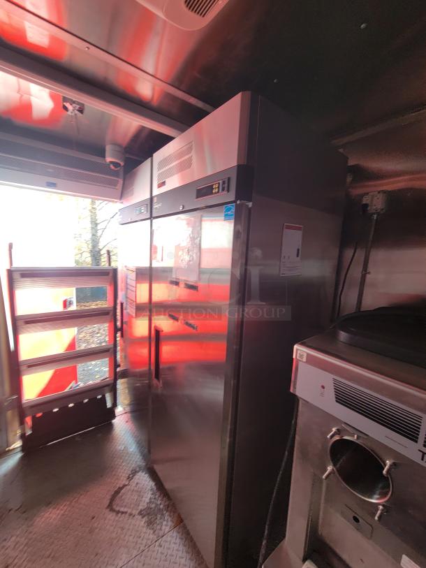 2021 28' Wendy's ghost kitchen trailer interior with high-end commercial appliances. Clean, efficient layout for delivery service.