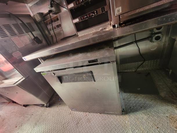 2021 28' Titanium Cargo Ghost Kitchen Trailer interior, featuring commercial appliances and stainless steel surfaces.