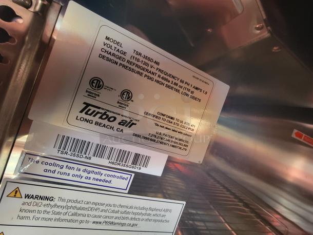 Label close-up of Turbo Air refrigeration system in a high-end mobile kitchen trailer. Model TSR-35SD-N6, details specifications and safety warnings.