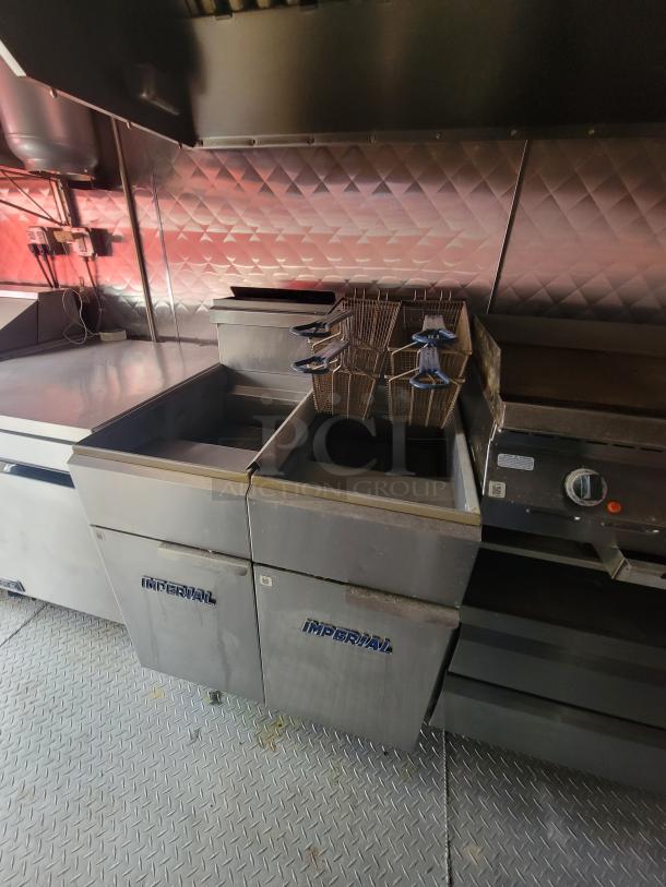 2021 Quality Kitchens 24' mobile food trailer interior. Features Imperial deep fryers, large gas griddle, and Econ-Air exhaust.