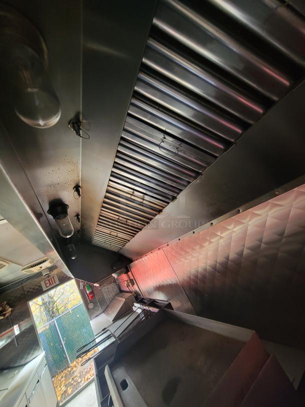 2021 24' Quality Kitchens Mobile Food Trailer interior with Econ-Air exhaust, Imperial fryers, and gas griddle, excellent condition.