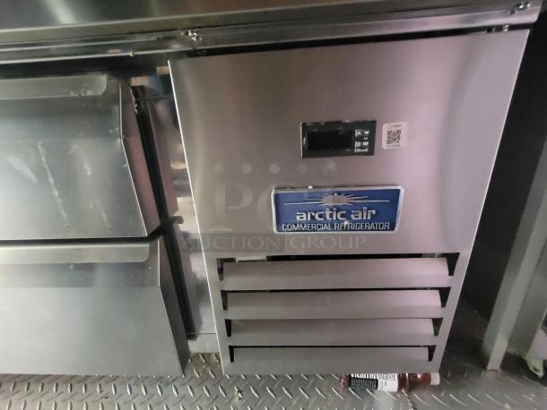 Arctic Air commercial refrigerator inside a 2021 Quality Kitchens 24' mobile food trailer. Stainless steel finish.