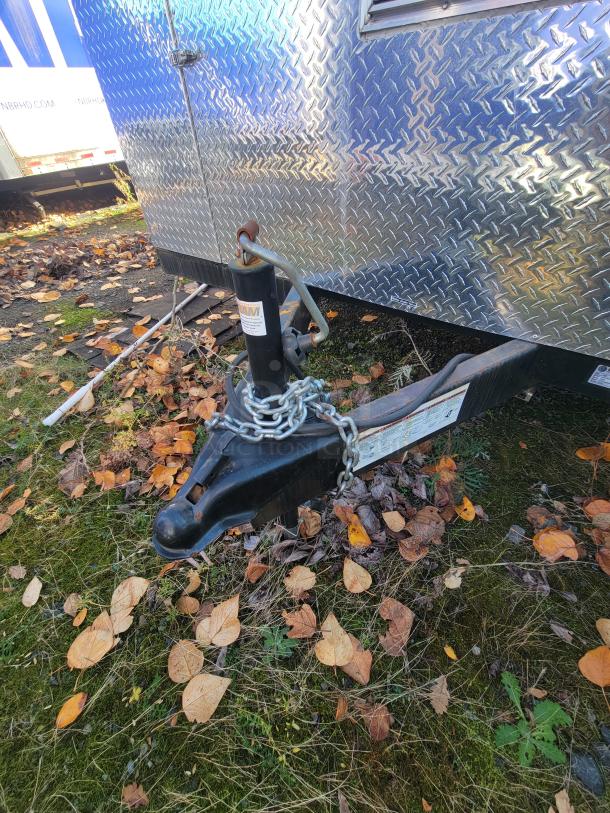 2021 Quality 24' food trailer with diamond-plate exterior, shown with trailer hitch and chain lock, in excellent condition.