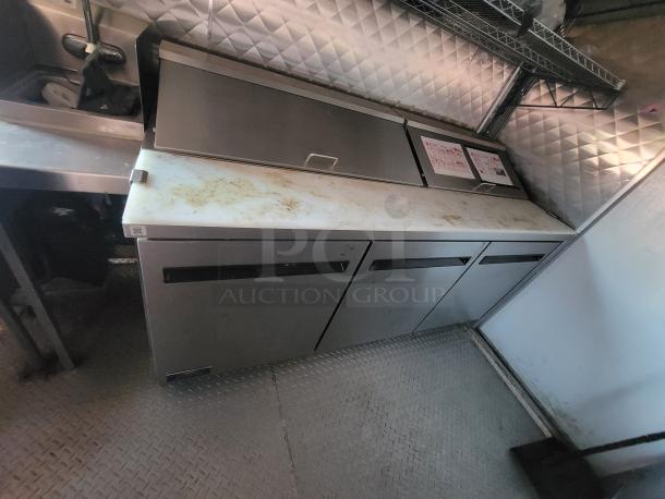 2021 24' Quality food trailer interior, showing stainless steel prep table in good condition with some surface wear.