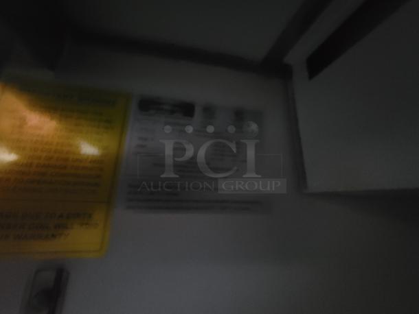 Blurry image of warning and informational labels inside a food trailer, specific details unclear.