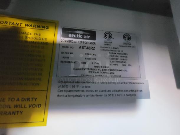 Arctic Air AST48RZ commercial refrigerator label displaying model, batch, refrigerant (R290), and specifications.