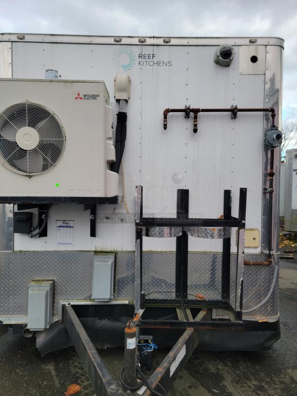 Rock Solid 16' mobile trailer exterior with Mitsubishi Electric HVAC unit and "REEF Kitchens" logo. Industrial fittings visible.