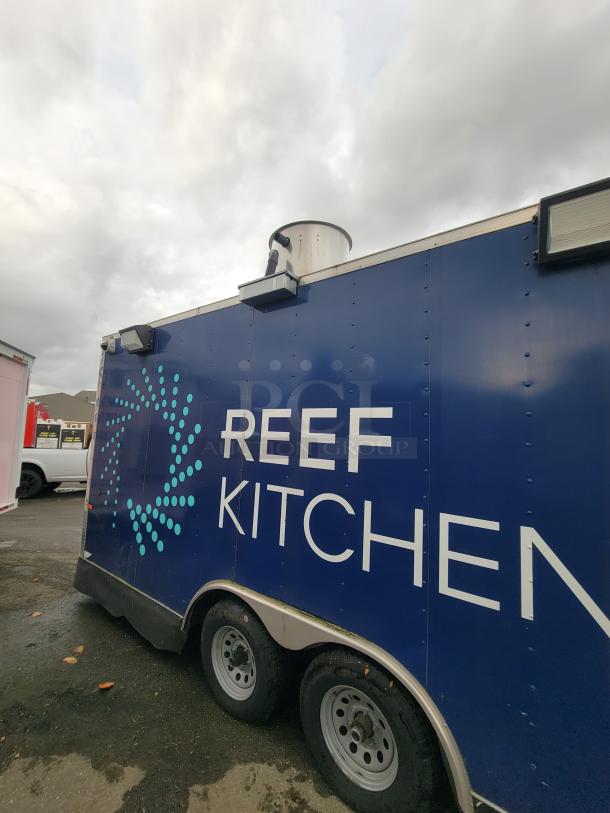 2020 Rock Solid 16' mobile kitchen trailer, blue exterior with "REEF KITCHEN" branding, dual axle, vent system visible.