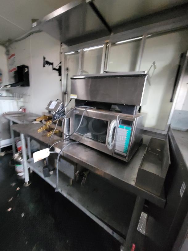 2020 Rock Solid 16' mobile trailer with high-end kitchen equipment, including a commercial fryer and prep table for food service.