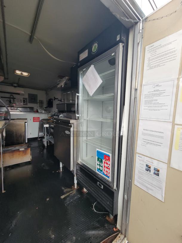 2020 Rock Solid 16' mobile kitchen trailer interior with Dukers glass-door merchandiser and Atosa prep table visible.