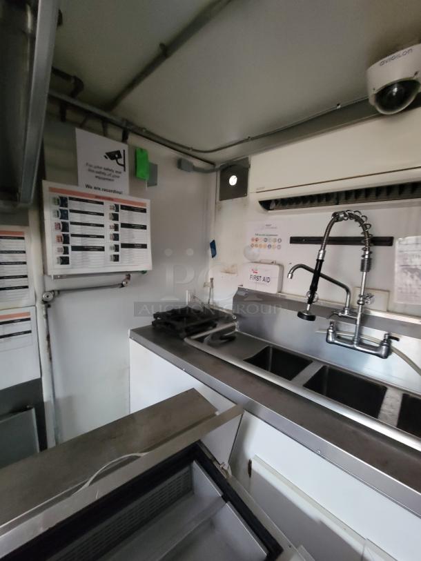 2020 Rock Solid 16' mobile kitchen interior with stainless steel sink, Avigilon camera, and kitchen equipment for ghost kitchen use.
