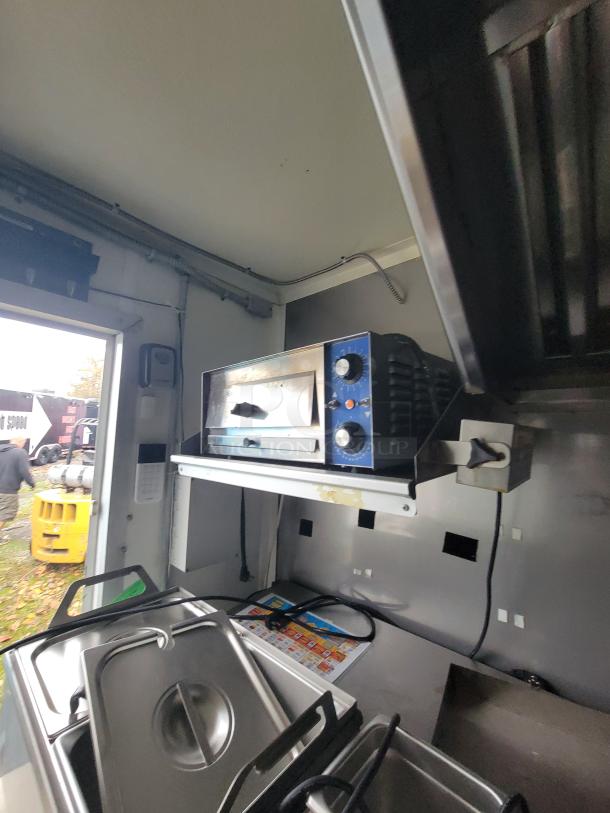 2020 Rock Solid 16' mobile ghost kitchen trailer, featuring high-end equipment, including ovens and stainless steel storage bins.