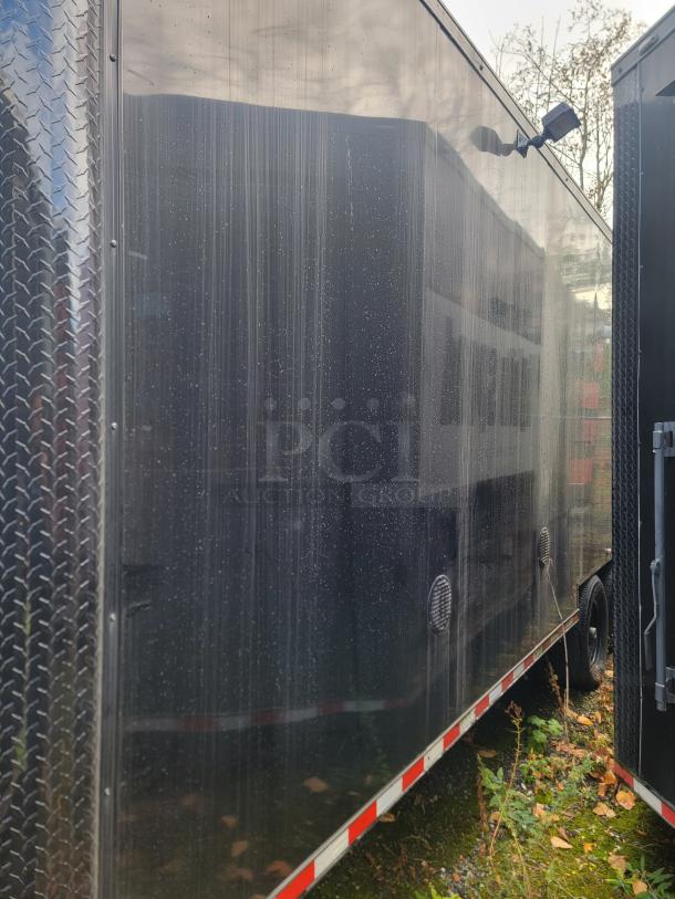 2021 24' SDG Refrigerated Trailer, 14,000 LB GVWR, black exterior, dual axles. Designed for commercial food service.