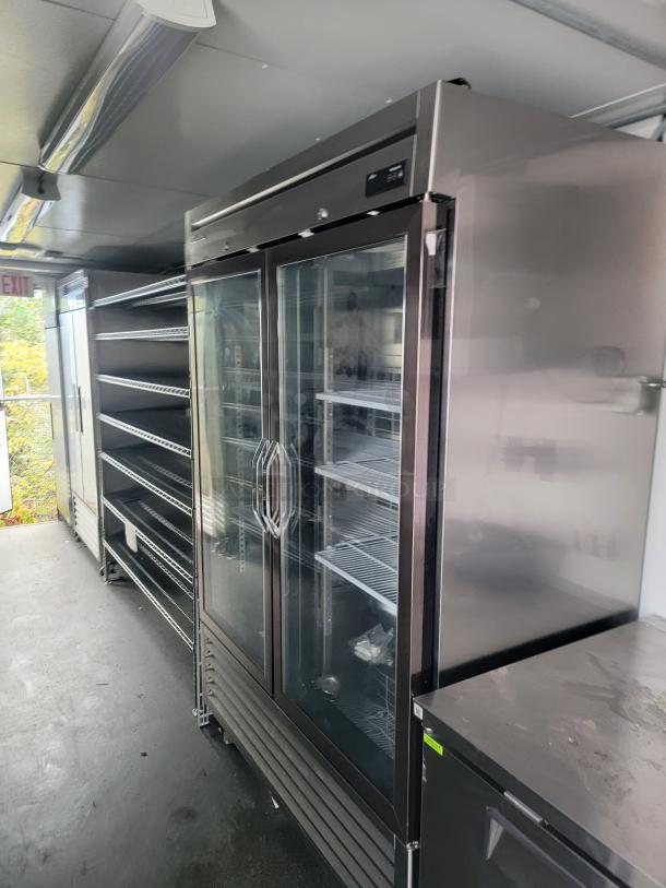 2021 SDG 24' refrigerated trailer interior with commercial coolers, chrome wire shelving, and stainless steel worktops.