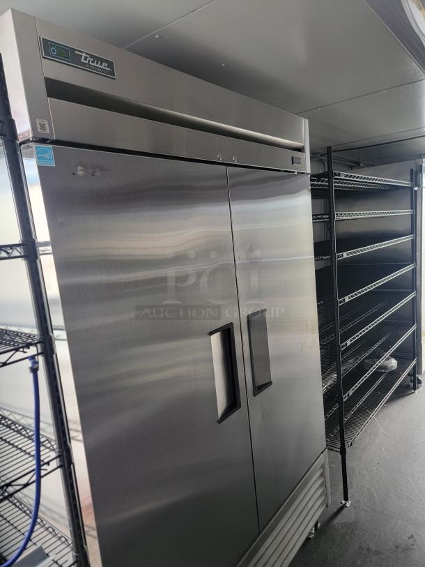 2021 SDG 24' refrigerated trailer interior featuring True commercial cooler, chrome wire shelving, and stainless steel worktops.