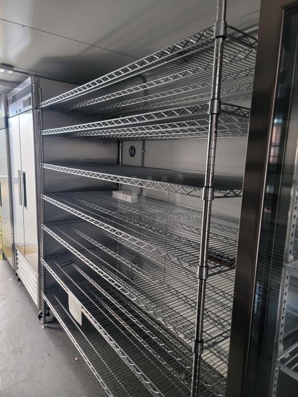 2021 SDG 24' refrigerated trailer interior, featuring chrome wire shelving and commercial coolers for mobile kitchen use.