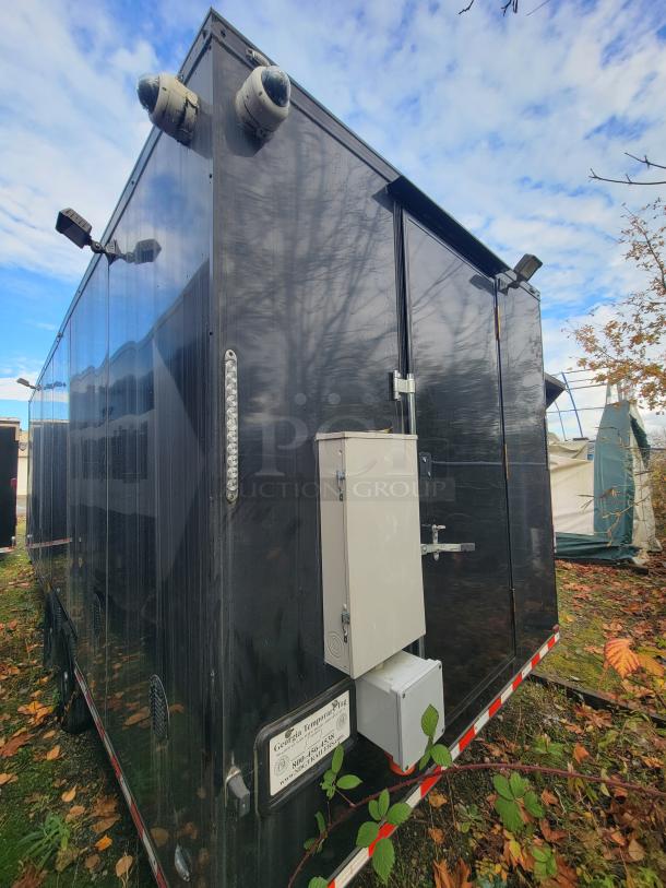 2021 SDG 24' refrigerated trailer, black exterior, dual axles, equipped with security cameras and electrical box.