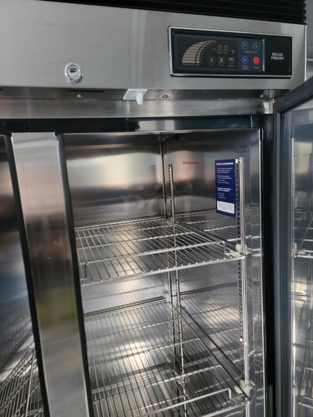 Interior of SDG refrigerated trailer with commercial cooler featuring chrome wire shelving and digital temperature display.