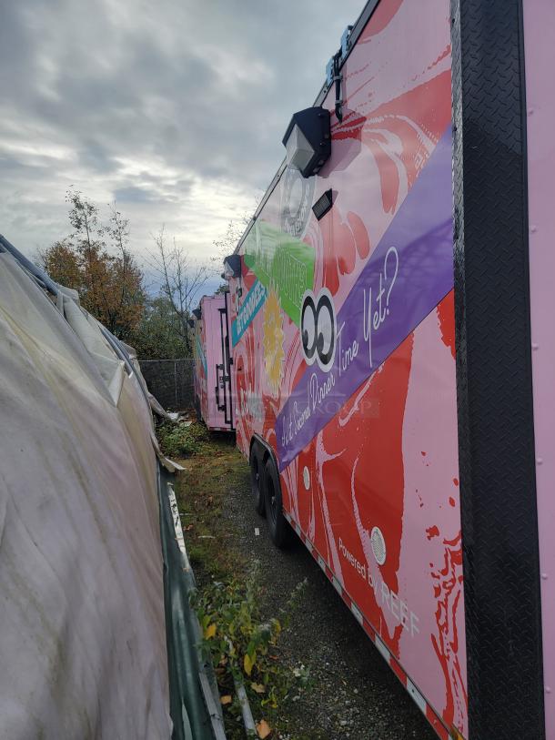 Commercial-grade mobile freezer trailer by SDG, Model 20, pink exterior with colorful graphics. Features high-end refrigeration and integrated IT/security system.