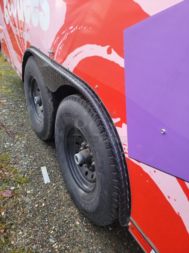 SDG 20 mobile retail/freezer trailer with Goodees Provisions branding, showing dual wheels and side details.