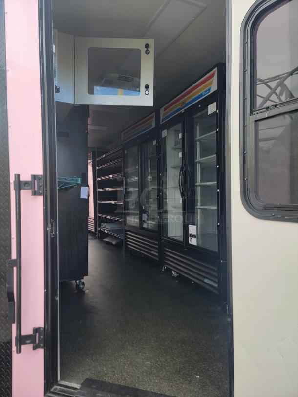 Mobile retail/freezer trailer interior with refrigeration units, chrome shelving, and sanitation station. SDG make, 8.5ft x 20ft.
