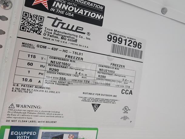 Label on commercial freezer showing model GDM-43F, True Manufacturing, with refrigerant R290, for mobile retail trailer.