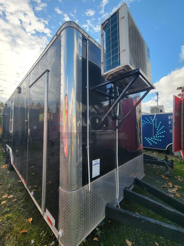 2021 Diamond Cargo 24' mobile trailer with HVAC. Black exterior featuring diamond plate accents. Ideal for food service.