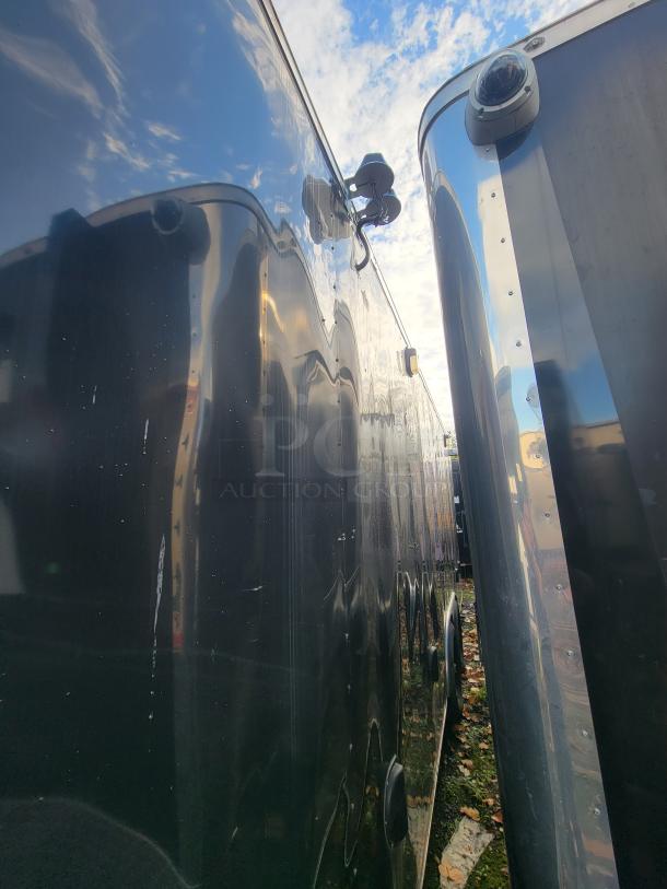 24-foot 2021 Diamond Cargo trailer exterior, equipped with surveillance camera, shown in pristine condition.