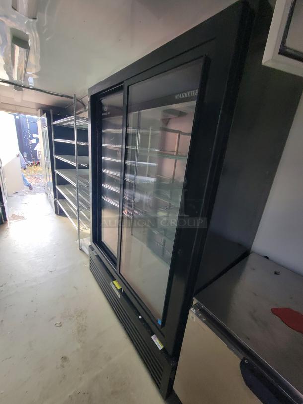 2021 Diamond Cargo trailer interior with Beverage-Air MTS-Series glass-door merchandiser and shelving units.