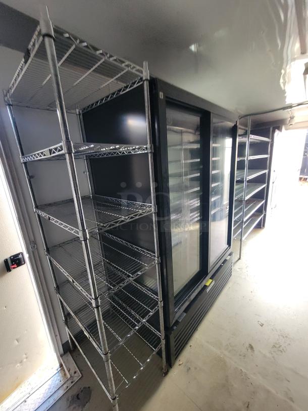 2021 24' Diamond Cargo mobile trailer interior with metal shelving and Beverage-Air glass-door merchandiser.